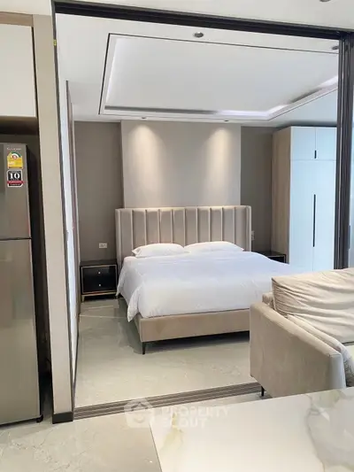 Modern bedroom with elegant decor and plush furnishings in a stylish apartment.