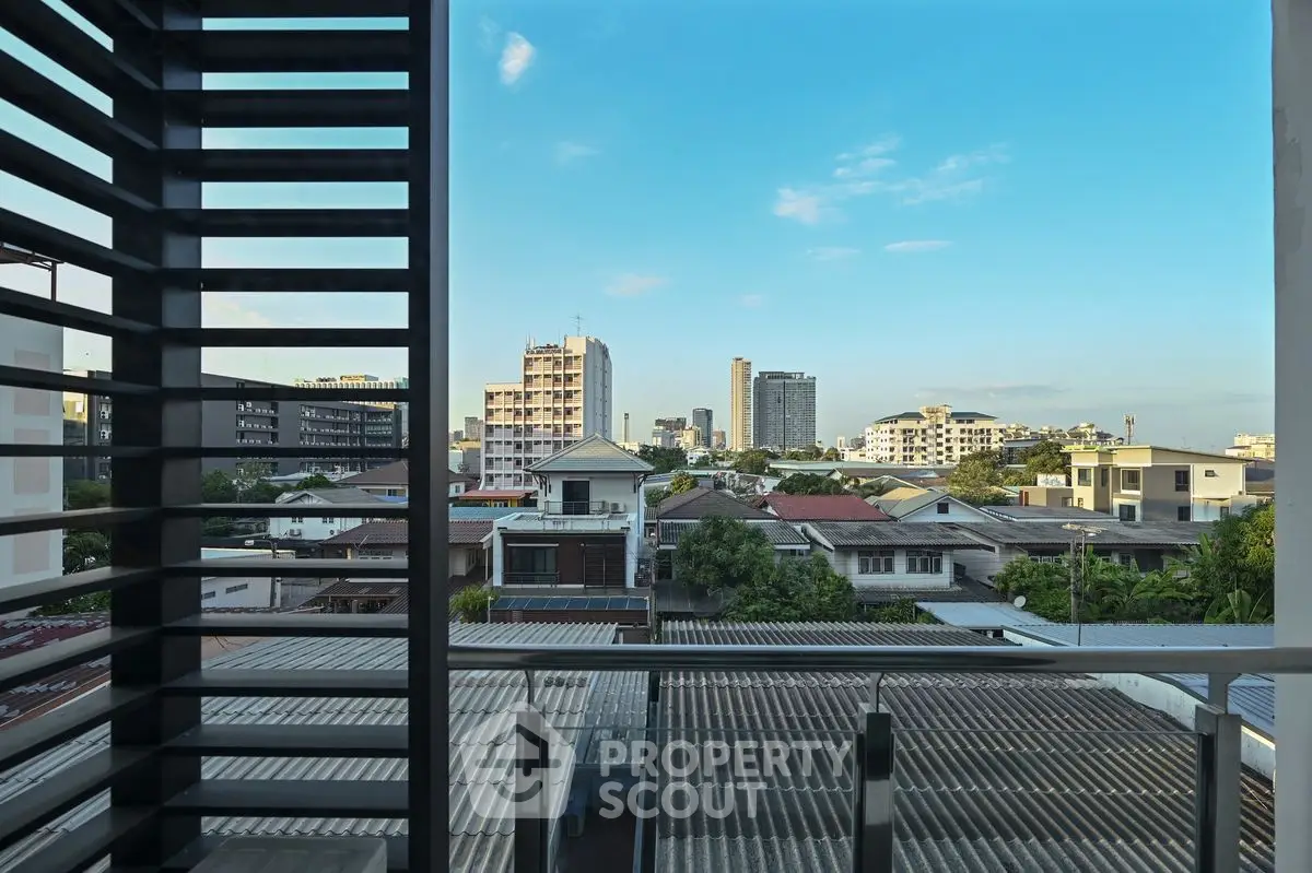 Stunning urban view from a modern balcony with city skyline backdrop.