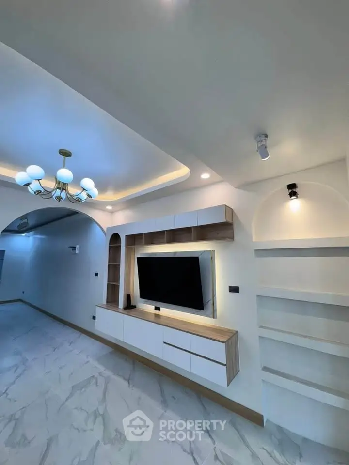 Modern living room with elegant lighting and built-in TV unit