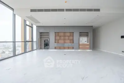 Spacious modern living room with floor-to-ceiling windows and city view