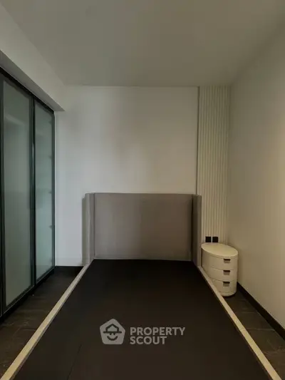 Modern minimalist bedroom with sleek design and ample storage space.