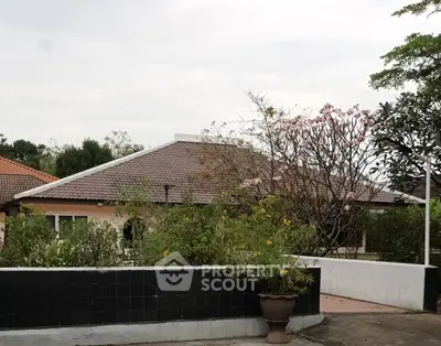 Charming suburban home with tiled roof and lush garden, perfect for family living.