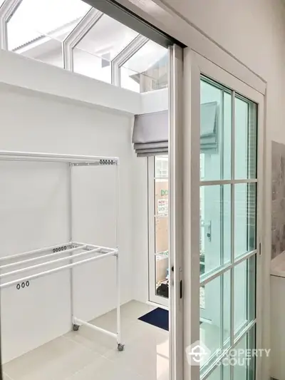 Bright laundry room with sliding glass door and ample natural light