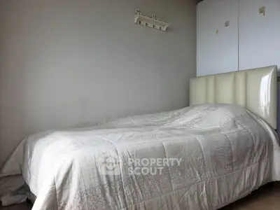 Cozy bedroom with elegant bedding and minimalist decor, perfect for relaxation and comfort.