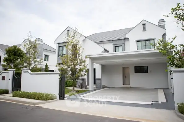 Elegant modern house with spacious driveway and lush greenery