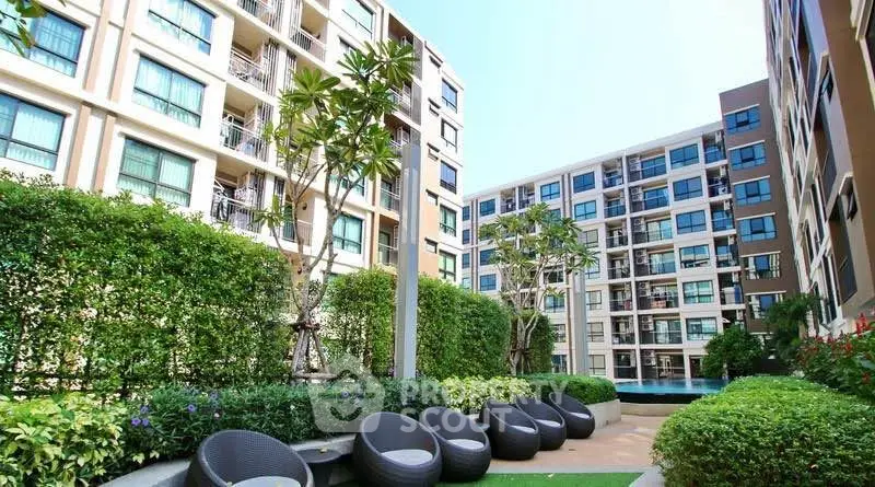 Modern apartment complex with lush garden and pool view