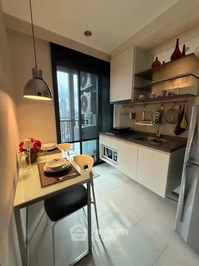 Modern kitchen with sleek design, featuring dining area and large window view.