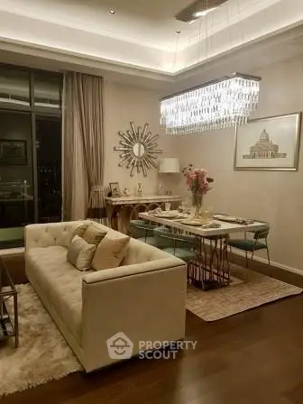 Luxurious living room with elegant chandelier and stylish decor in modern apartment.