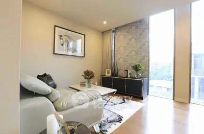 Modern living room with stylish decor and large windows offering natural light.