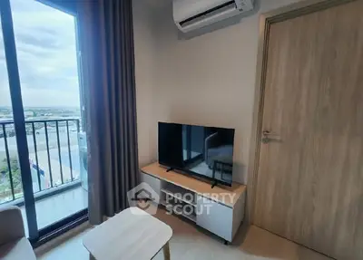 Modern living room with balcony view and sleek TV setup