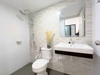 Modern bathroom with sleek fixtures and stylish tile design, perfect for contemporary living.