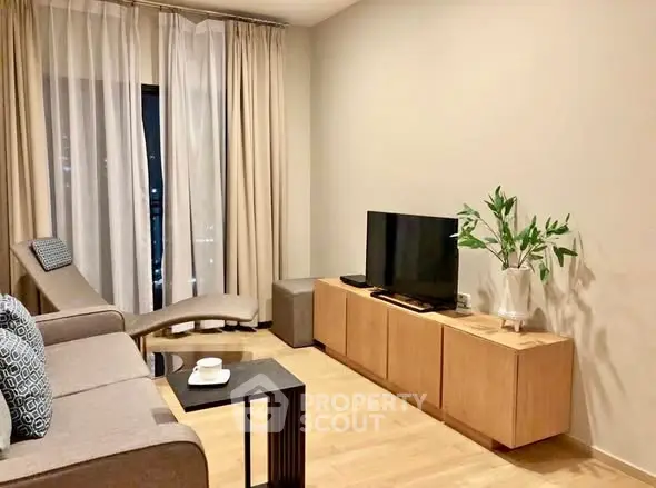 Modern living room with sleek furniture and natural light, perfect for relaxation and entertainment.