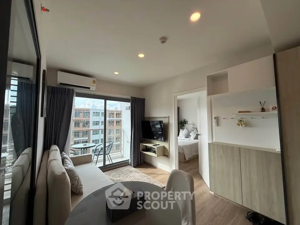 Modern apartment living room with balcony and bedroom view