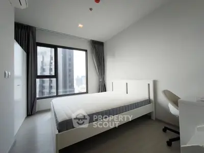 Modern minimalist bedroom with large window and city view