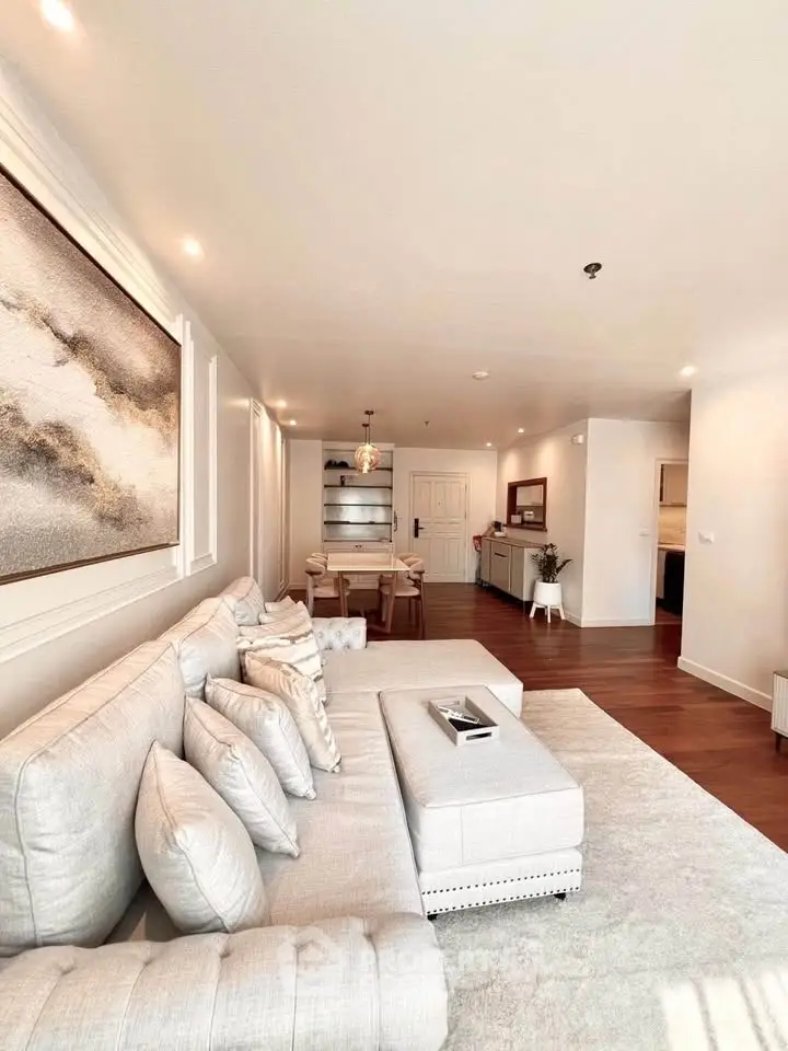 Spacious and elegant living room with modern decor and ample natural light.