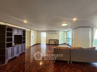 Spacious living room with elegant wooden flooring and modern furnishings