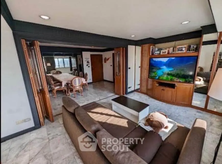 Spacious living room with modern decor and open layout to dining area