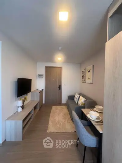 Modern living room with cozy seating and stylish decor in a contemporary apartment.