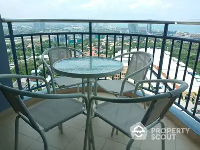 Stunning high-rise balcony with panoramic city and ocean views, perfect for relaxation and entertainment.