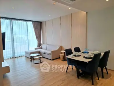 Spacious modern living room with elegant dining area and natural light