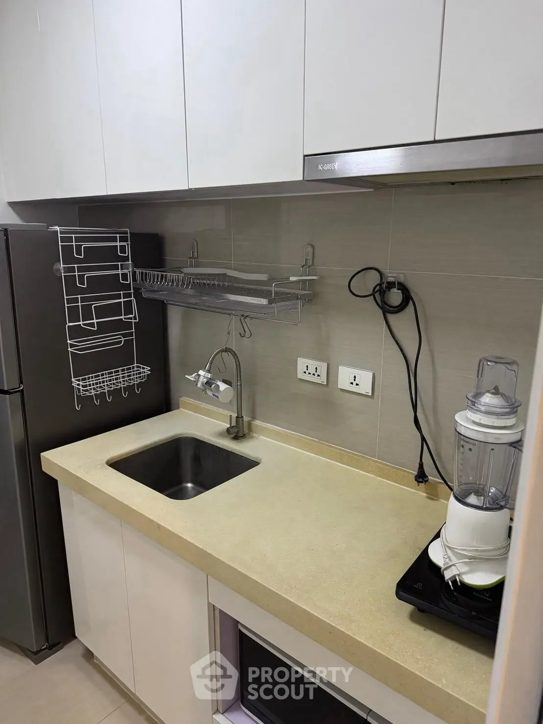 Modern kitchen with sleek cabinets and appliances, featuring a compact design and efficient layout.