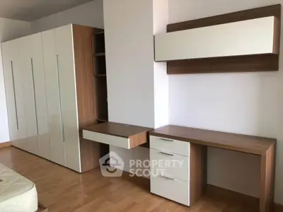 Modern bedroom with sleek built-in wardrobe and stylish wooden desk