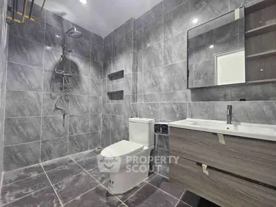 Modern bathroom with sleek gray tiles and contemporary fixtures
