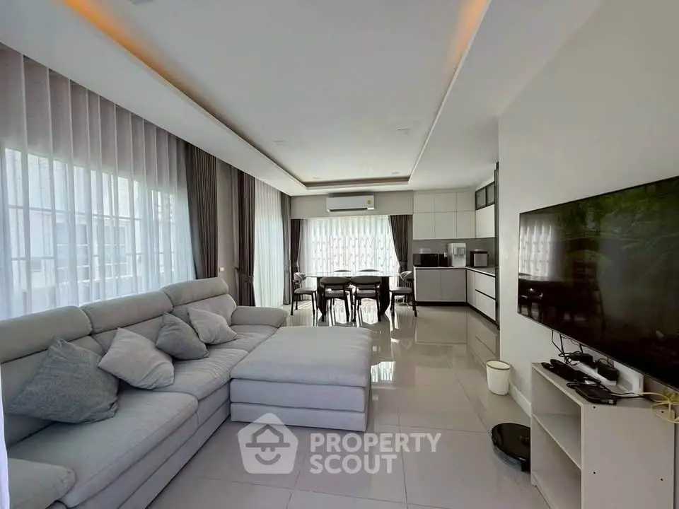 Spacious modern living room with open kitchen and sleek decor