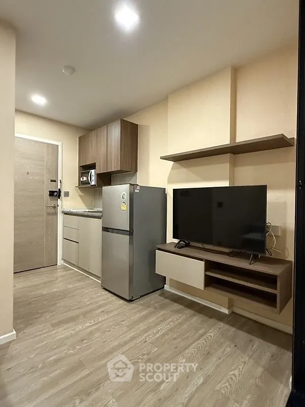 Modern compact living space with kitchen and entertainment area