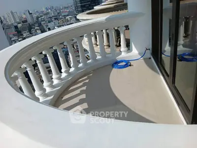 Stunning curved balcony with city skyline view, perfect for relaxation and enjoying urban living.