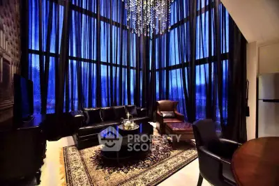 Luxurious living room with high ceilings and elegant chandelier