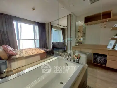 Luxurious bedroom with ensuite bathroom featuring a modern bathtub and elegant decor.