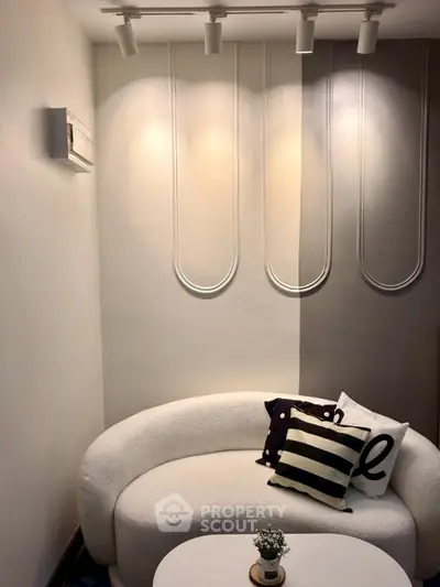 Stylish modern living room with unique wall design and cozy seating