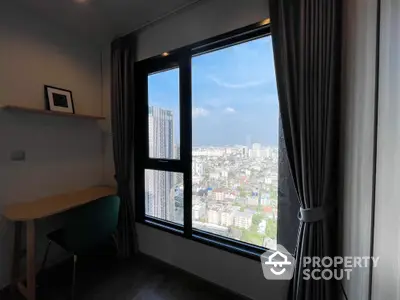 Stunning city view from modern high-rise apartment with cozy study nook.