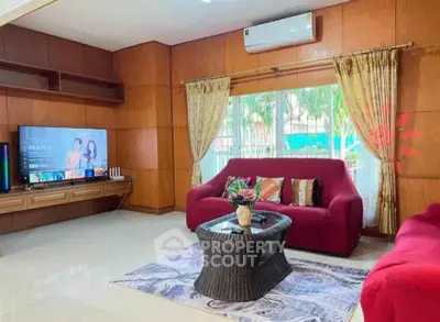 Spacious living room with modern decor and large window view