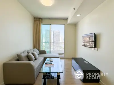 Modern living room with city view, stylish sofa, and wall-mounted TV in high-rise apartment.