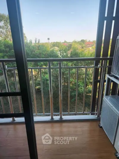 Charming balcony with lush green view, perfect for relaxation and enjoying nature.