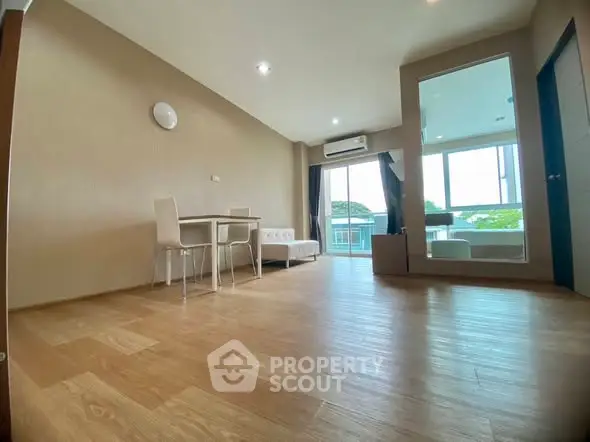 Spacious living room with modern furniture and large windows offering natural light.