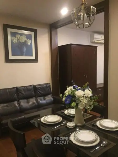 Elegant dining area with modern decor and cozy seating in a stylish apartment.