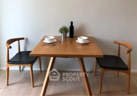 Stylish dining area with modern wooden table and chairs, perfect for cozy meals.