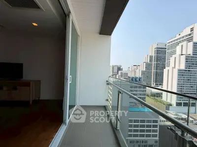Spacious balcony with stunning city view in modern high-rise apartment