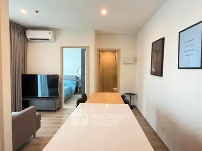 Modern apartment interior with open layout, featuring a cozy living area and stylish bedroom.