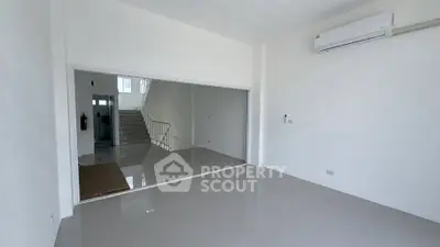 Spacious modern living room with sleek tile flooring and air conditioning, perfect for comfortable living.