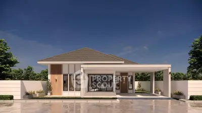 Modern single-story house with sleek design and spacious driveway under clear blue sky.