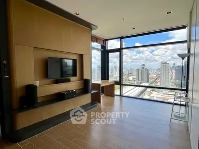 Spacious modern living room with stunning city view and sleek wooden flooring.