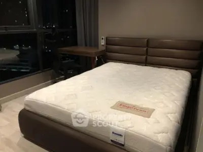 Cozy bedroom with modern furniture and large window view