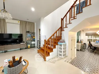 Spacious modern living room with stylish staircase and open layout