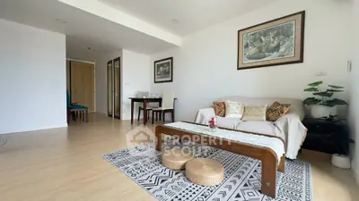Spacious living room with modern decor and cozy seating area in a stylish apartment.