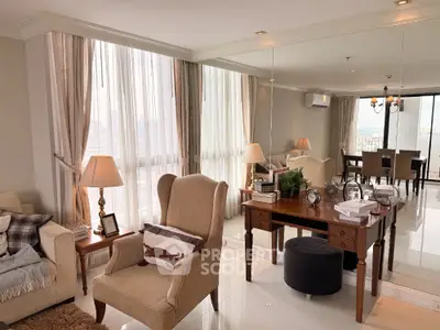Luxurious living room with elegant decor and large windows offering stunning city views.