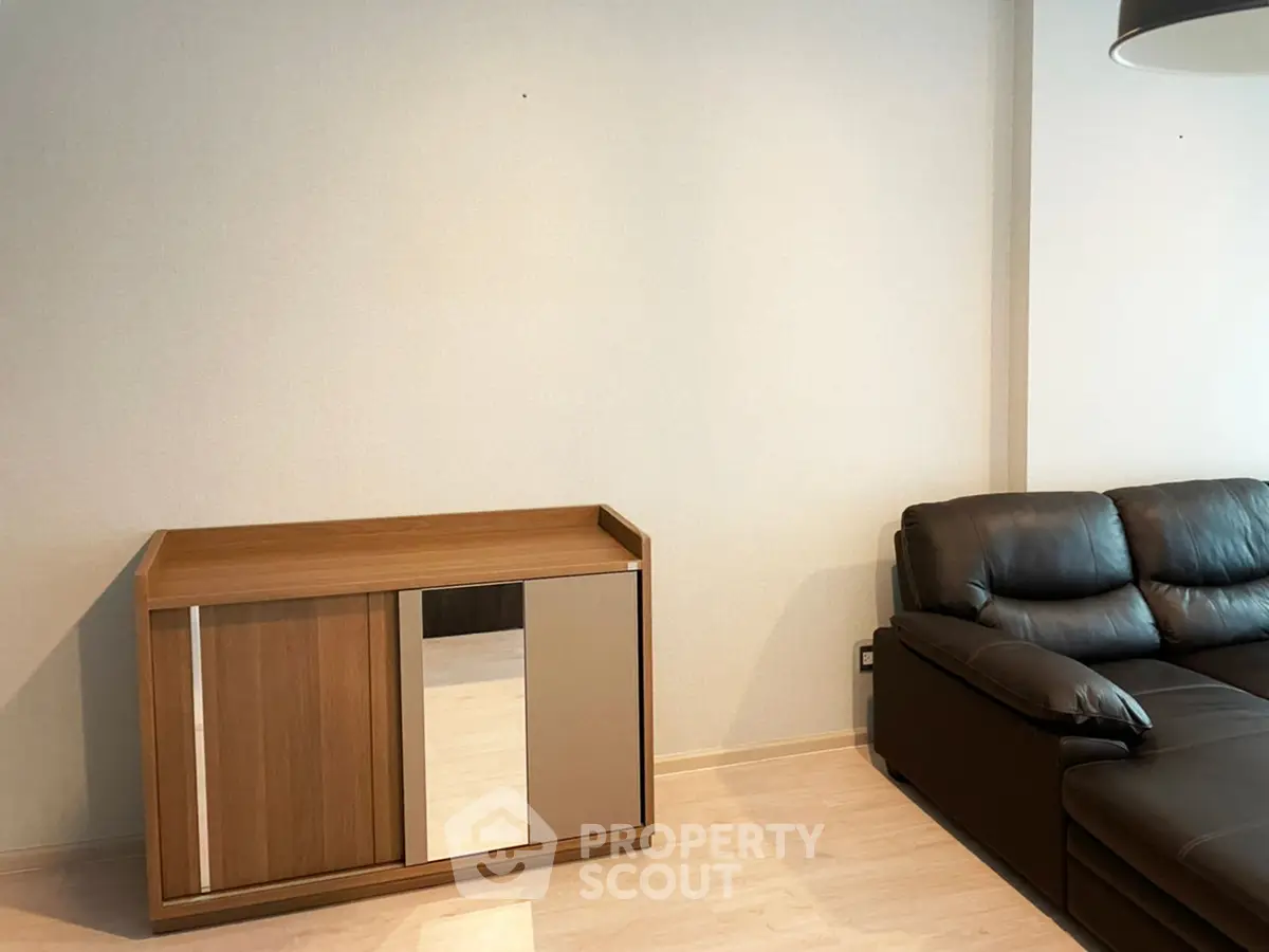 Modern living room with sleek leather sofa and stylish wooden cabinet
